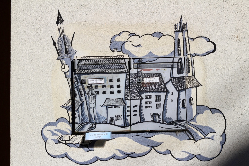 A drawing of Fribourg painted on top of two mailboxes. 